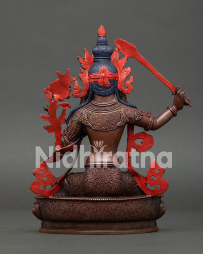 Back view of Manjushri statue showing handcrafted copper body and traditional Nepalese Buddhist art.