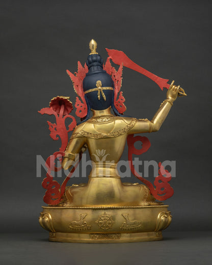Back view of Manjushri Statue showing intricate crown and lotus pedestal detail