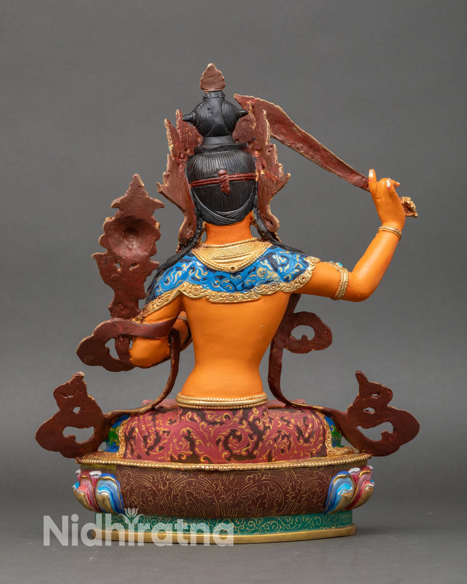 Back view of Manjushri Statue with detailed carvings and lotus base design