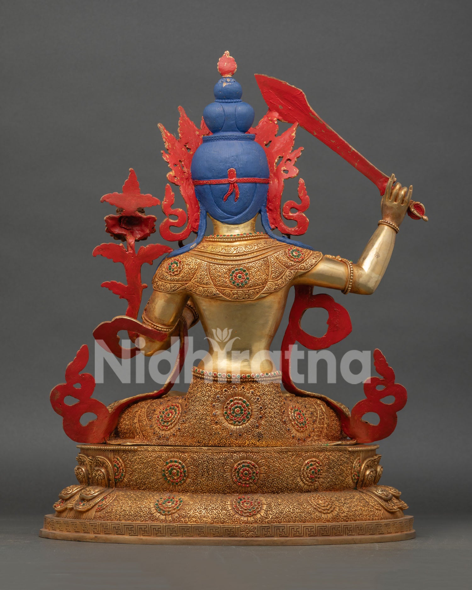 back view of manjushri statue with detailed copper craftsmanship and gold finish
