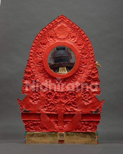Back view of Manjushri statue with red-painted repousse halo and engraved gold-gilded base