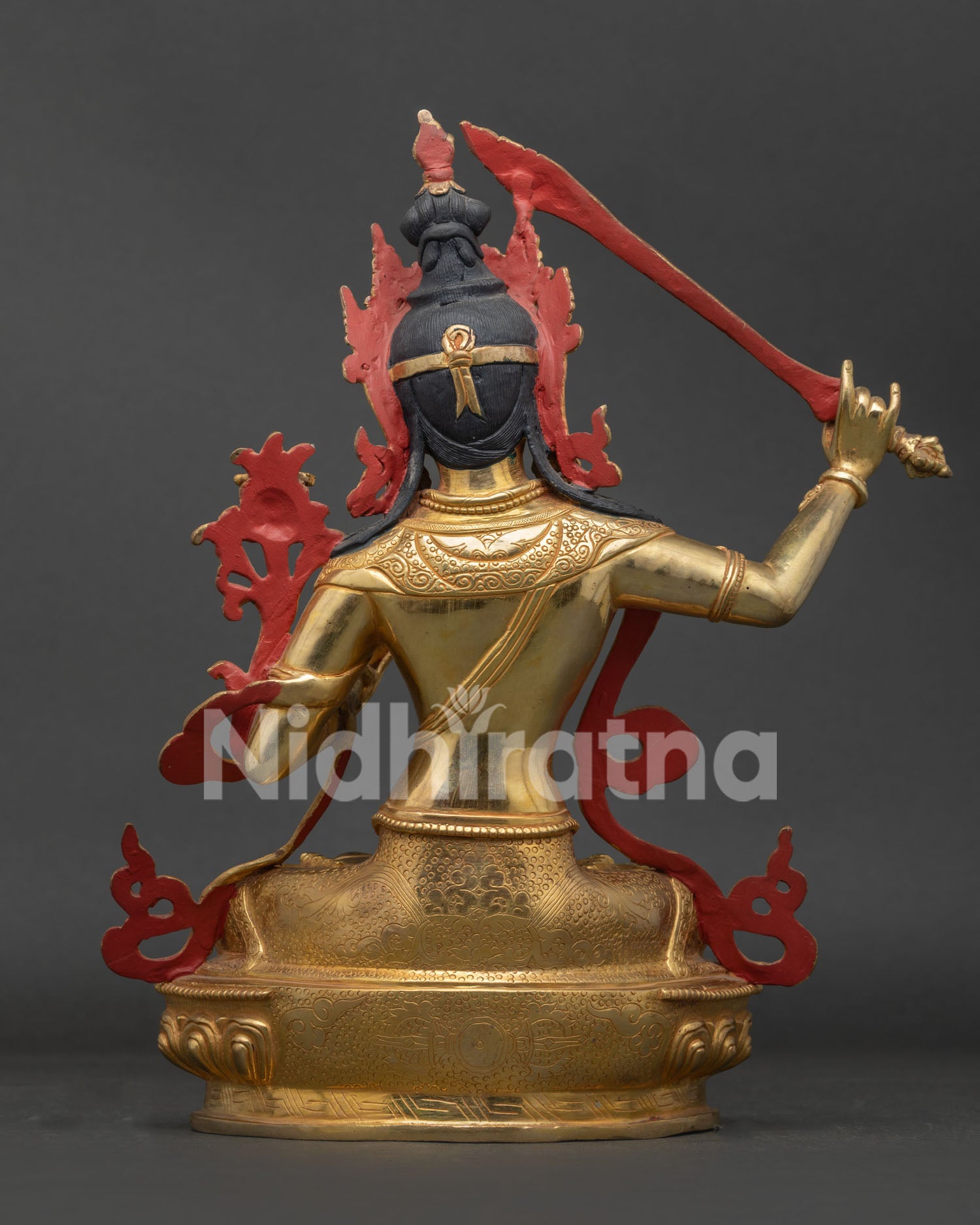 Back view of Manjushri statue with vajra symbol carved on lotus seat and Nepalese craftsmanship.