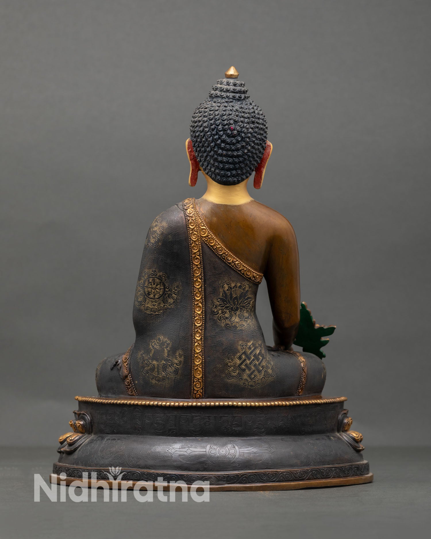 Back view of Medicine Buddha statue Nepalese handmade sacred sculpture with intricate detailing oxidized copper finish and traditional Vajrayana Buddhist healing iconography