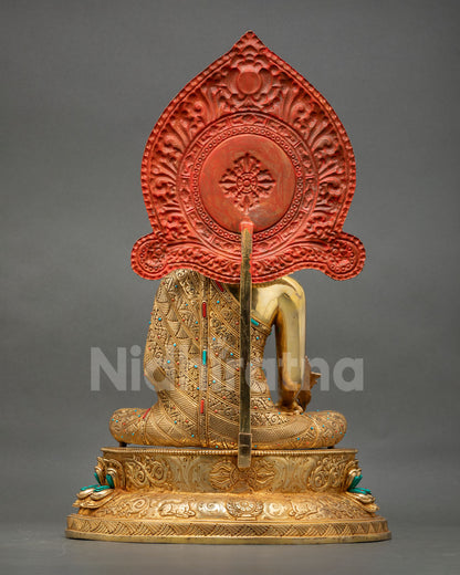 back view of medicine buddha statue with detailed halo and handcrafted carvings