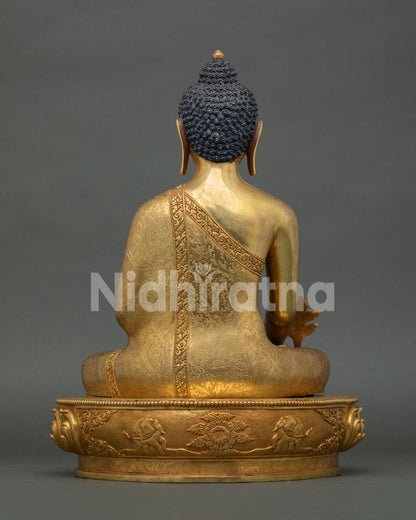 back view of medicine buddha statue with detailed robe carvings and lotus pedestal