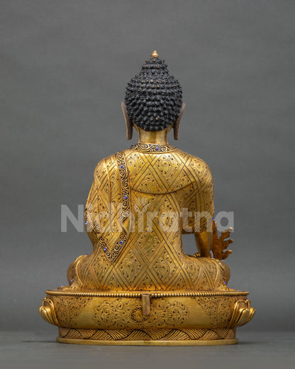 Back view of Medicine Buddha statue with hand-engraved robe and lotus base, handmade in Nepal