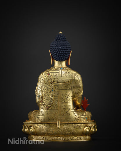 Back view of Medicine Buddha statue with turquoise inlaid mantra on lotus seat, Nepal
