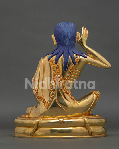 Back view of Milarepa statue, revealing detailed gilded robes and handcrafted Nepalese Buddhist artwork