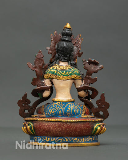 back view of mini white tara statue with detailed robe patterns and sacred design