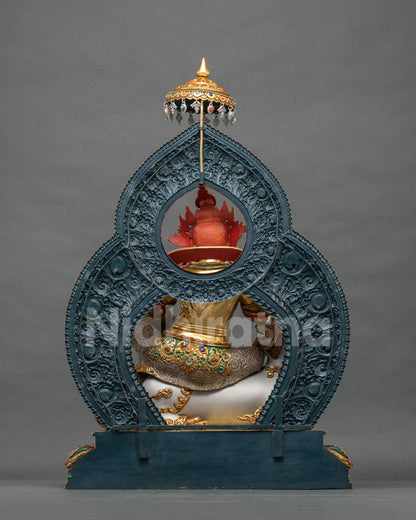 Back view of Namtoshe statue showing gold-gilded copper body and red crown detail