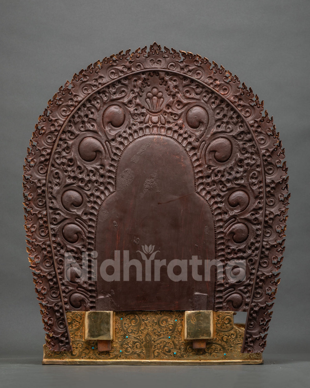 Back view of Namtoshe statue showing hand-engraved gold base and snow lion