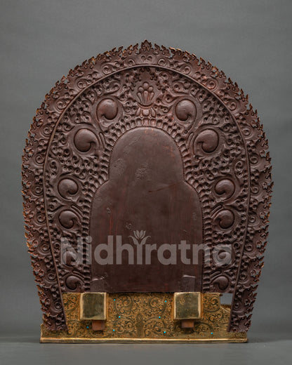 Back view of Namtoshe statue showing hand-engraved gold base and snow lion