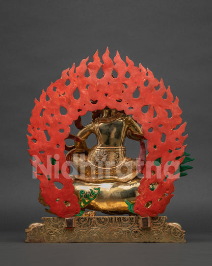 Back view of Namtoshe Statue showing red painted flame halo and engraved lotus base