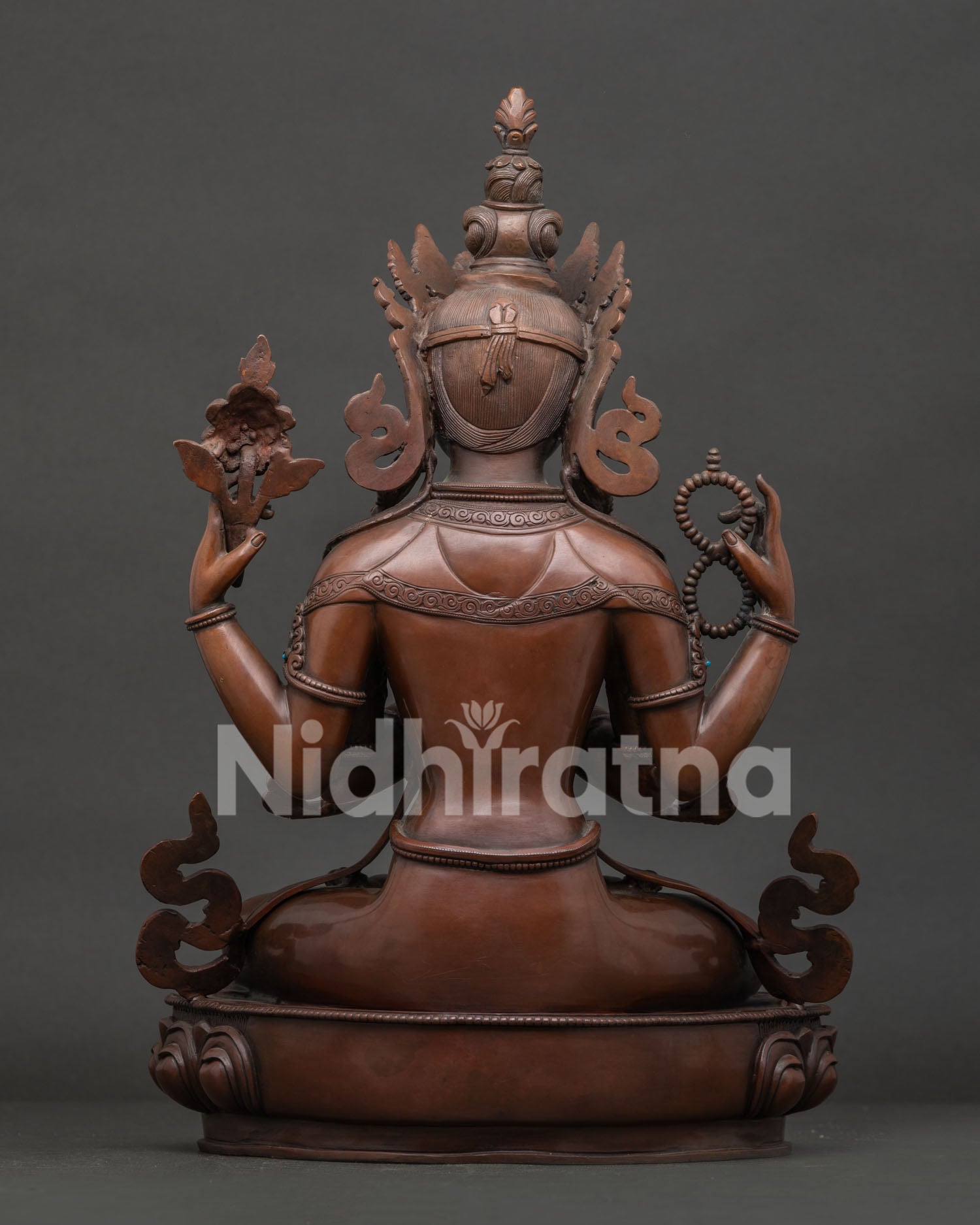 Back view of Nepalese Chenrezig statue with oxidized copper artwork and sacred details