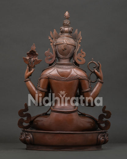 Back view of Nepalese Chenrezig statue with oxidized copper artwork and sacred details