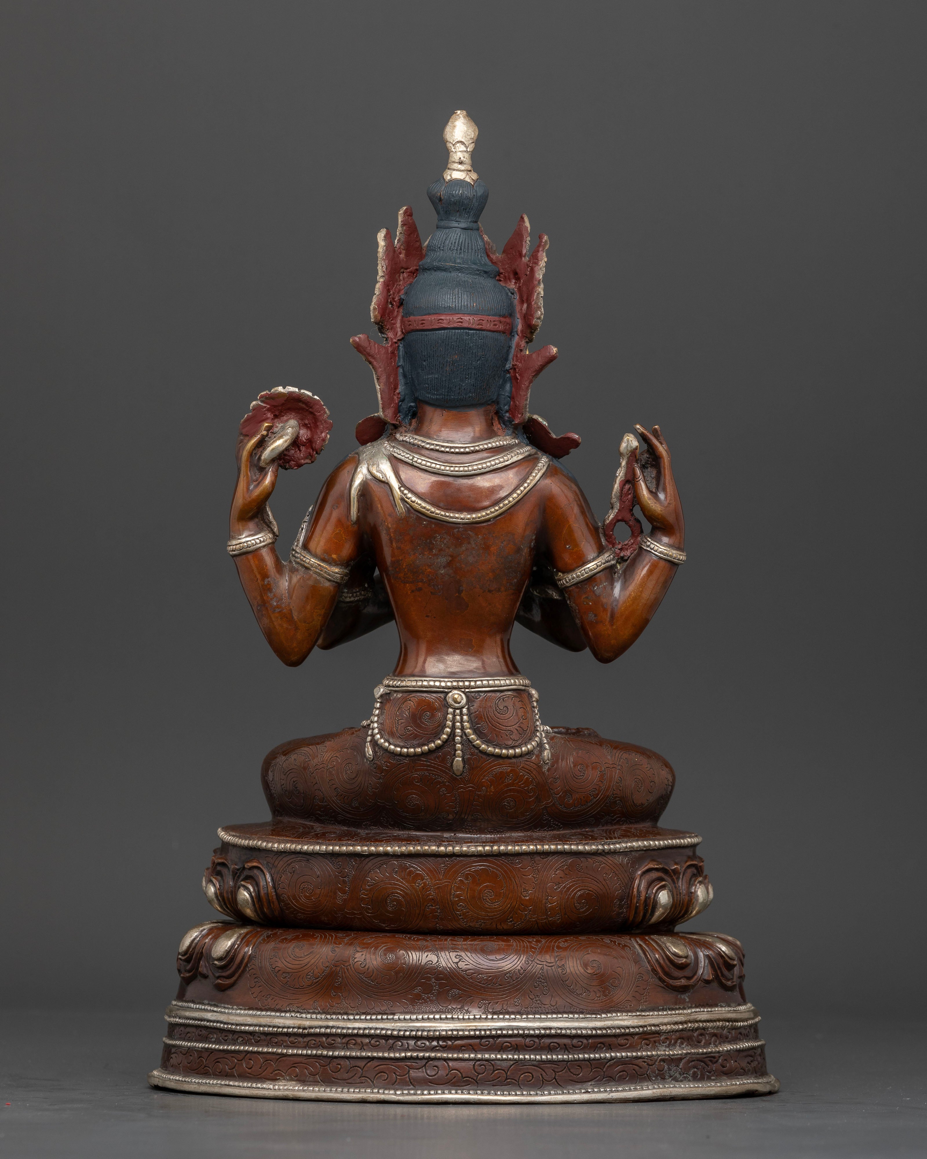 Back view of Nepalese Chenrezig statue with silver plated finish and intricate Buddhist details