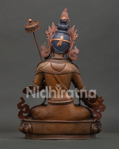 Back view of Nepalese Dukar statue with oxidized copper finish and intricate details