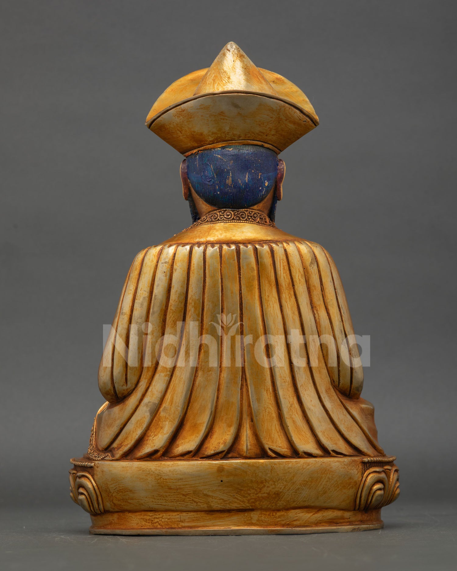 Rear view of Zhabdrung Ngawang Namgyal statue showing detailed robes and traditional craftsmanship