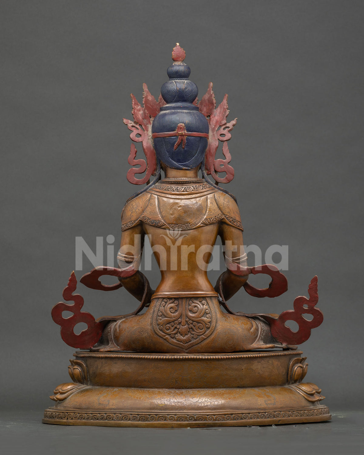 Back view of oxidized copper Amitayus Buddha statue on carved lotus pedestal