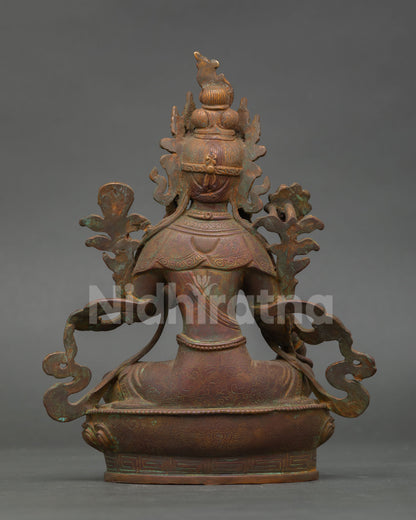 Back view of oxidized copper green tara statue featuring detailed craftsmanship and antique patina