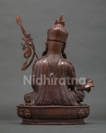 Back view of oxidized copper Guru Rinpoche statue showing robe detailing, handcrafted in Nepal