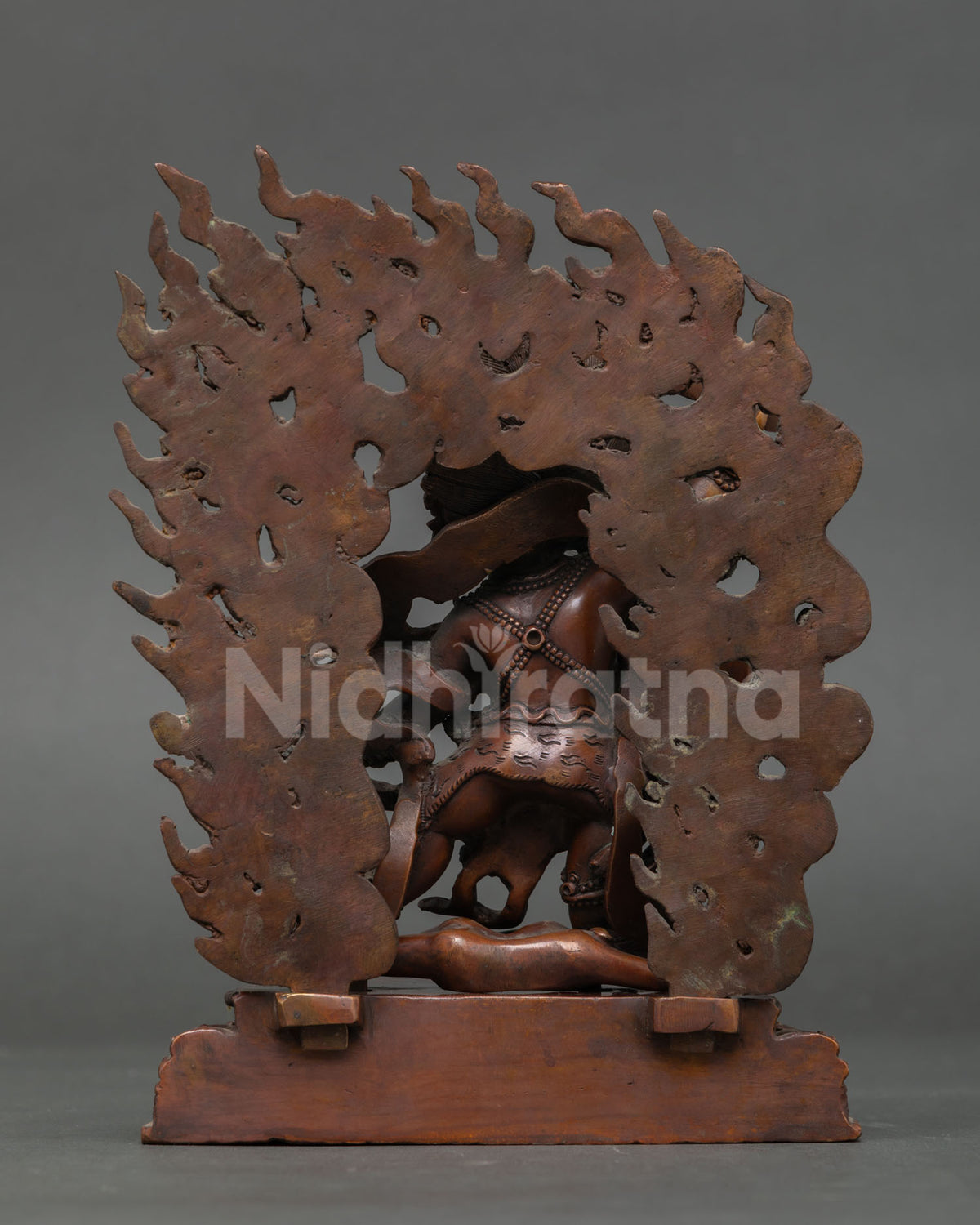Back view of Oxidized Copper Khadgapani Mahakala Statue showing flame halo and base