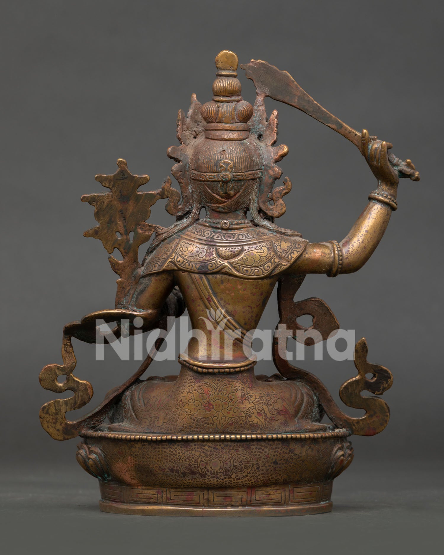 back view of oxidized copper manjushri statue with detailed buddhist sculpture work