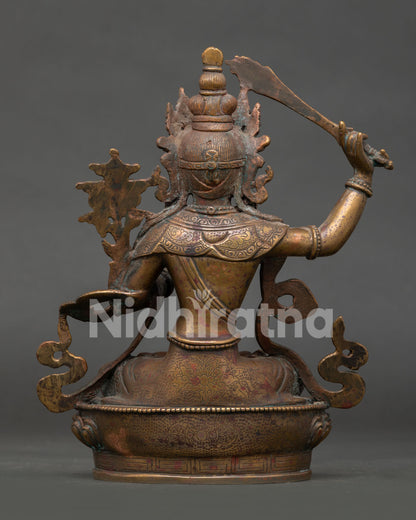 back view of oxidized copper manjushri statue with detailed buddhist sculpture work