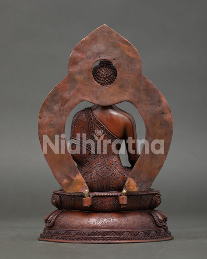 back view of oxidized copper medicine buddha statue with decorative halo details