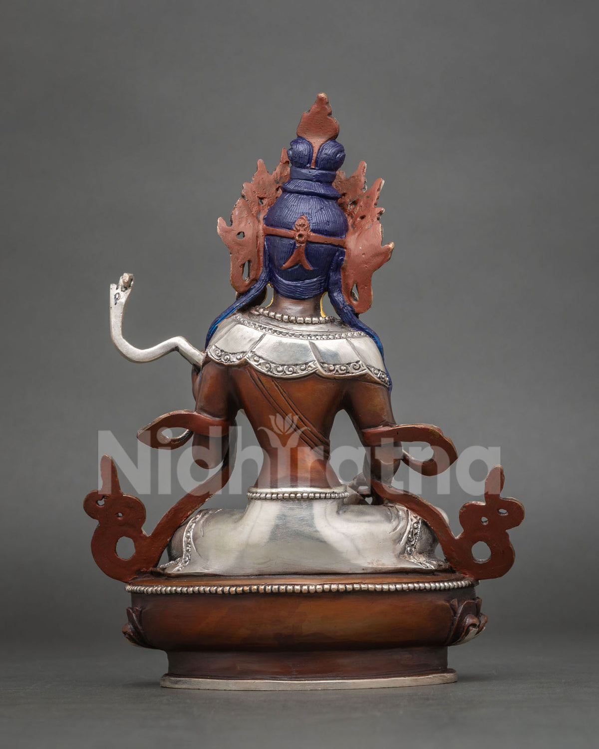 Back view of oxidized copper Saraswati statue with blue hair detail and silver-plated base