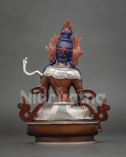 Back view of oxidized copper Saraswati statue with blue hair detail and silver-plated base