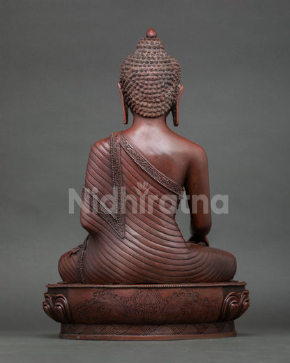 Back view of oxidized copper Shakyamuni Buddha statue detailed robe and lotus seat