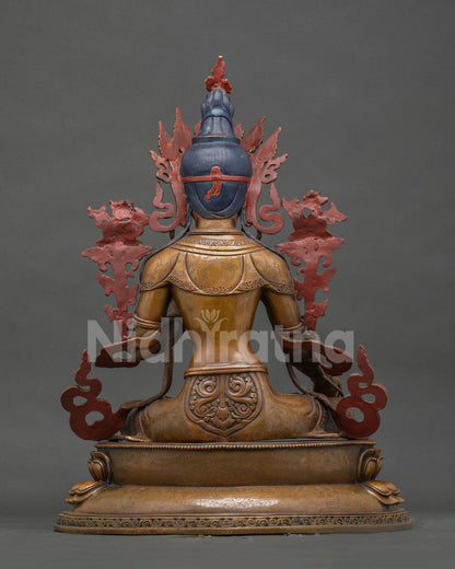 Back view of oxidized copper White Tara statue on carved lotus pedestal