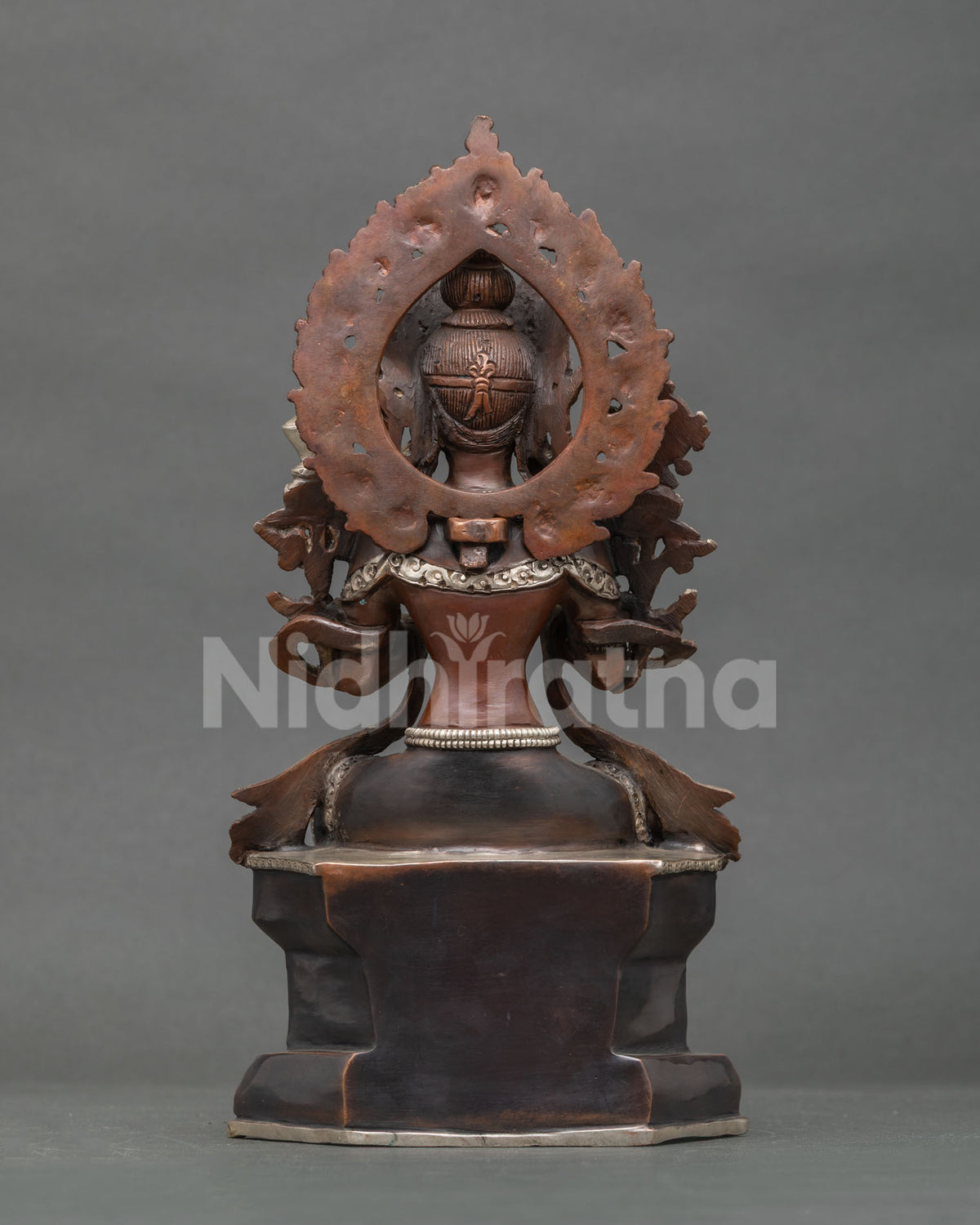 Back view of oxidized Maitreya Buddha statue showing rear halo, throne base, and patina finish