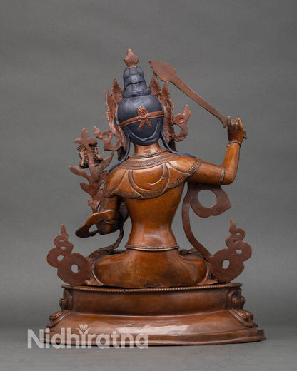 Back view of oxidized Manjushri statue highlighting intricate craftsmanship and sacred design.