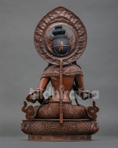 Back view of oxidized Vajrasattva statue with detailed carvings and lotus seat