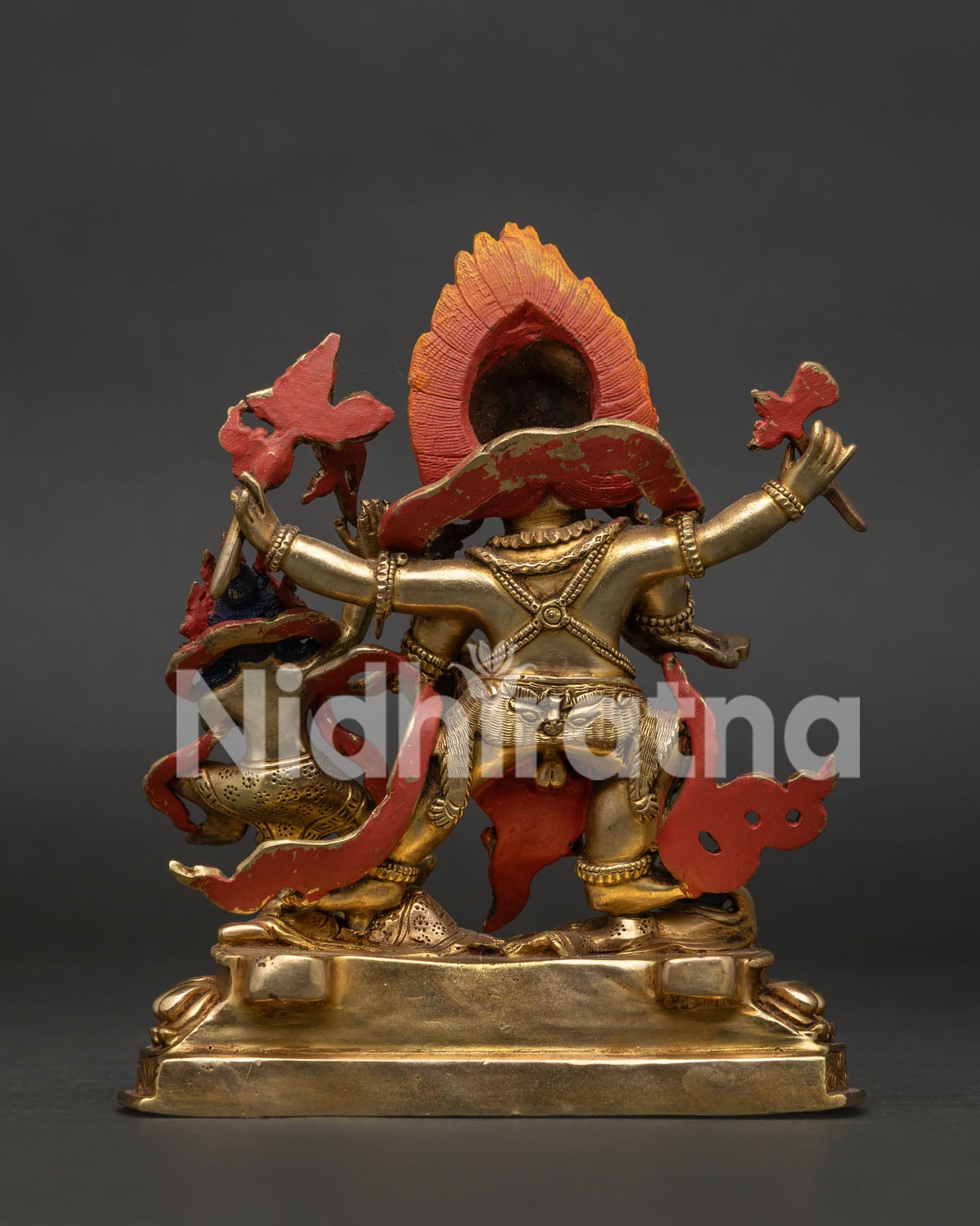 Back view of Red Dzambhala statue with detailed 24K gold plated copper finish