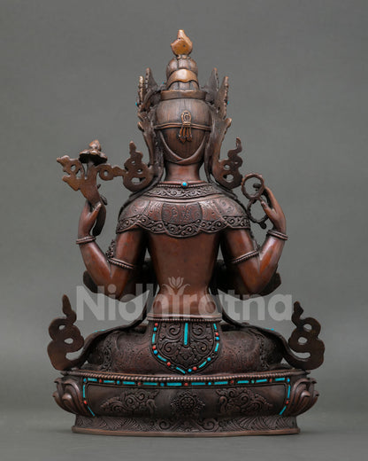 Back view of sacred Chenrezig statue from Patan Nepal showing traditional metal artistry oxidized texture and detailed lotus base
