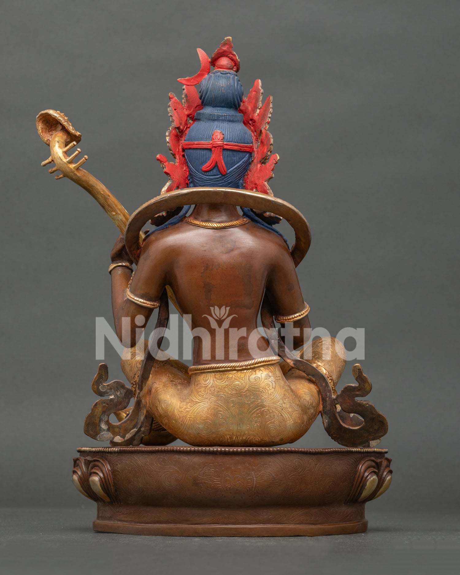 Back view of Saraswati statue showing ornate halo lotus pedestal and traditional Nepalese craftsmanship.