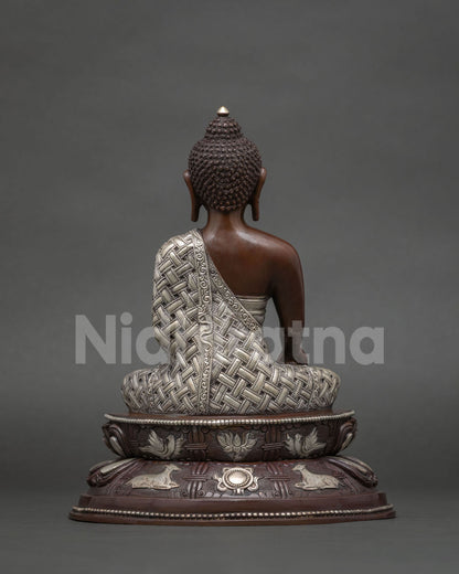 Back view of shakyamuni buddha lotus pedestal carved with dharmachakra symbol and two pairs of deer.