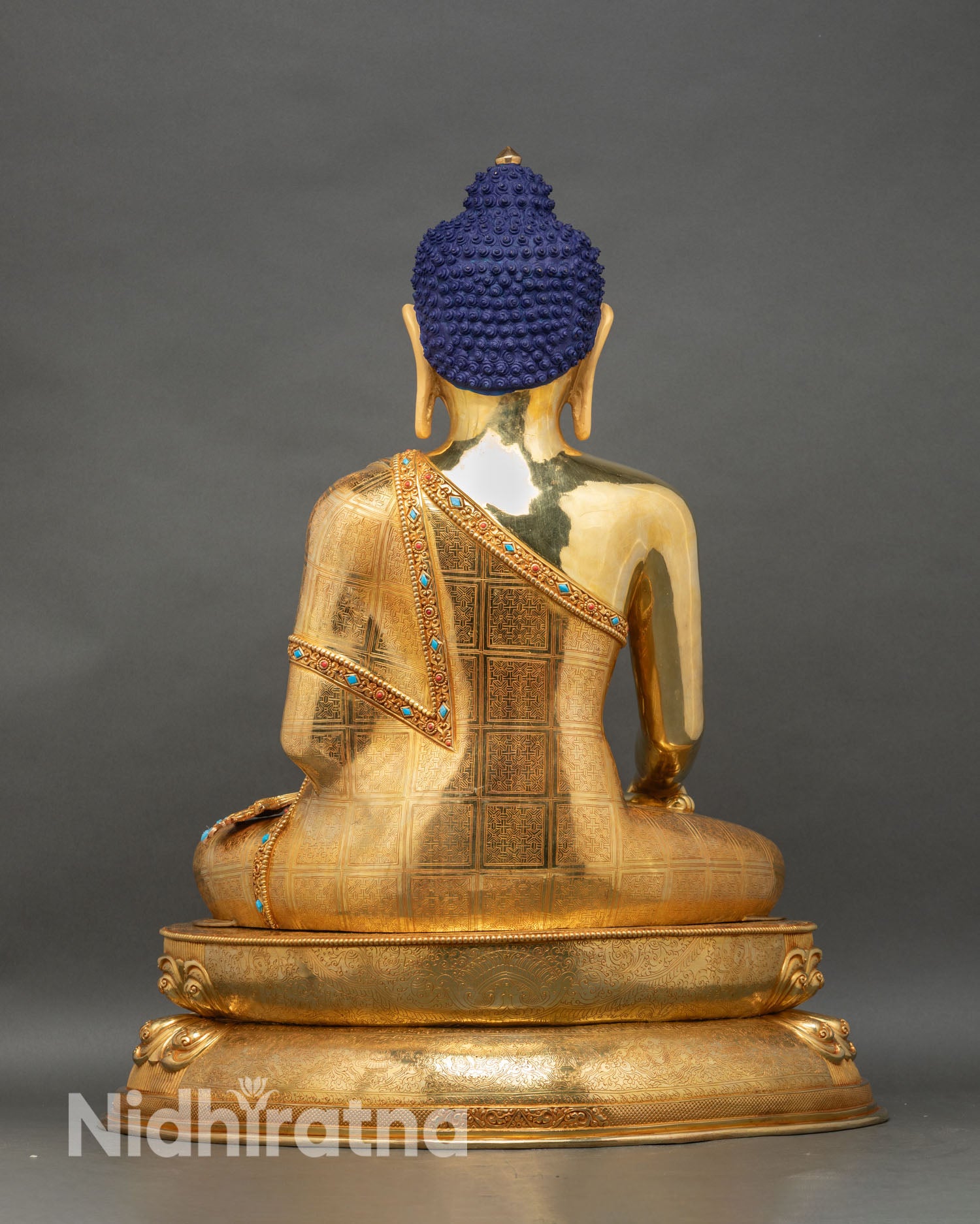 Back view of Shakyamuni Buddha statue, decorated lotus throne and traditional Newari craftsmanship