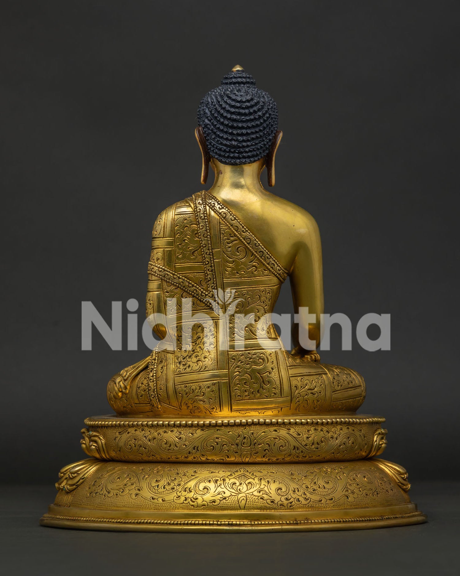 Back view of Shakyamuni Buddha Statue featuring detailed monastic robe engraving and lotus base