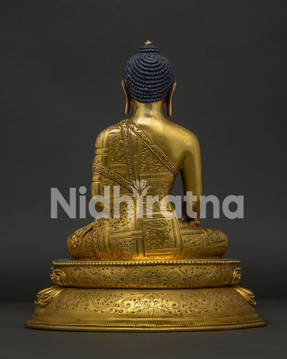 Back view of Shakyamuni Buddha Statue featuring detailed monastic robe engraving and lotus base