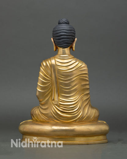 Back view of Shakyamuni Buddha statue gold gilded copper artwork from Nepal Newari artisan craftsmanship designed for meditation altar and spiritual decor
