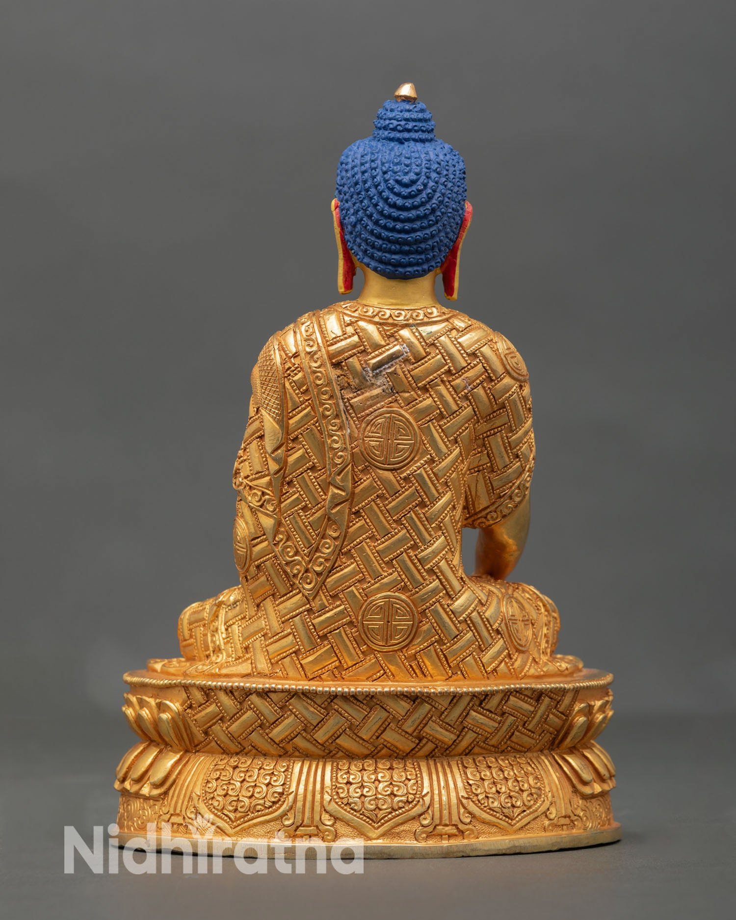 Back view of Shakyamuni Buddha statue handcrafted Nepal Newari craftsmanship lotus base detail copper metalwork spiritual Buddhist decor