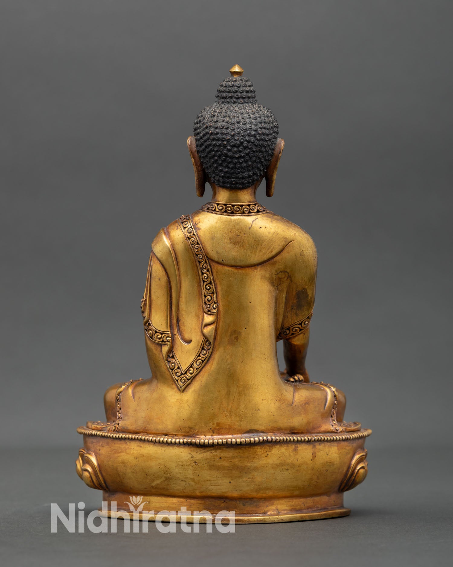 Back view of Shakyamuni Buddha statue handmade Himalayan Buddhist sculpture with antique inspired finish intricate detailing and spiritual home decor altar piece