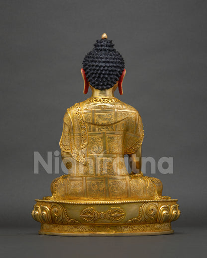 Back view of Shakyamuni Buddha statue showing gold-gilded robe patterns