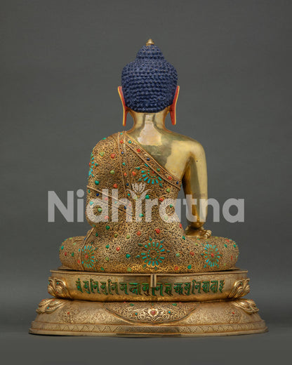 Back view of Shakyamuni Buddha statue showing hand carved robe and halo