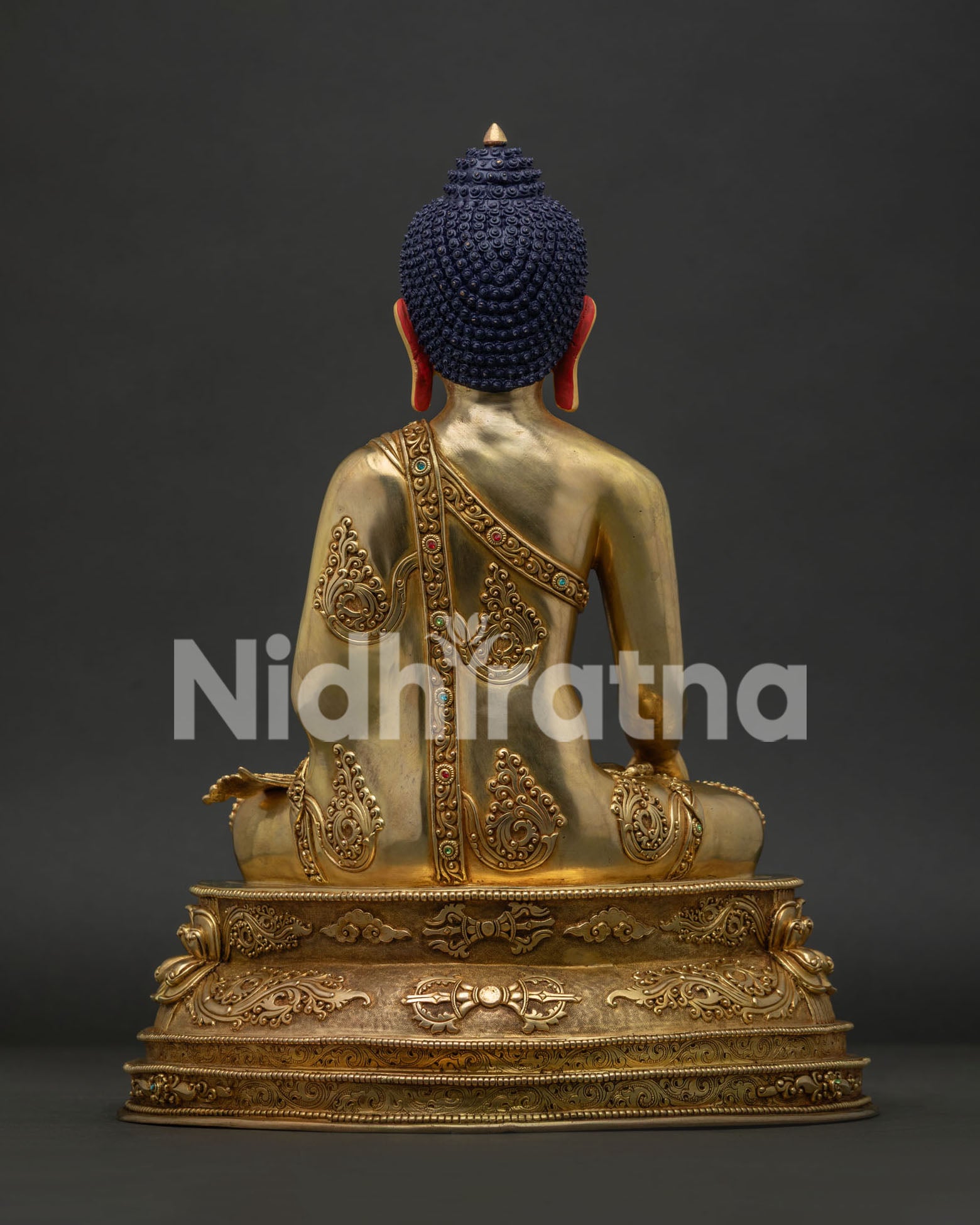 Back view of Shakyamuni Buddha statue showing handcrafted copper sculpture details