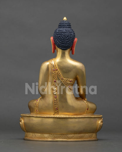 Back view of Shakyamuni Buddha statue showing sanghati robe carving detail